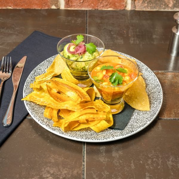 Havana 151's guacamole and ceviche with plantain chips and tortilla chips on a patterned plate.
